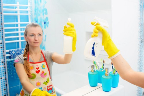 Cleaner following safe cleaning procedures with protective equipment