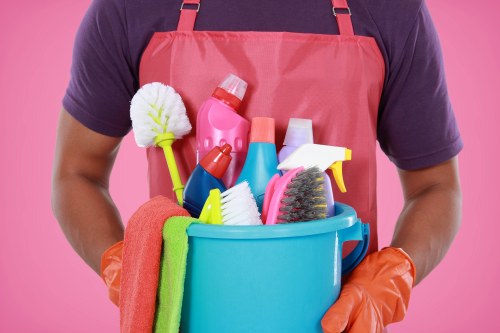Professional home cleaner in NW1 preparing a tidy living room