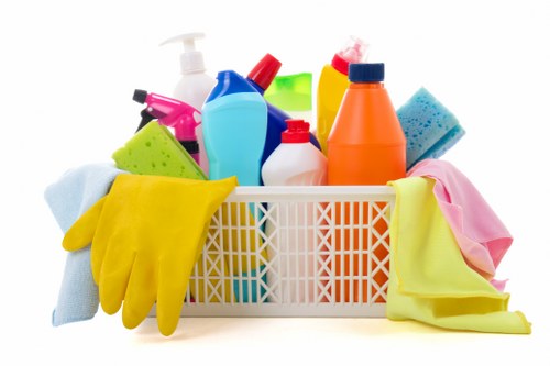 Office cleaning team sanitizing desks and shared surfaces in NW1