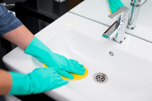 Technician performing sofa cleaning in NW1 in a modern flat